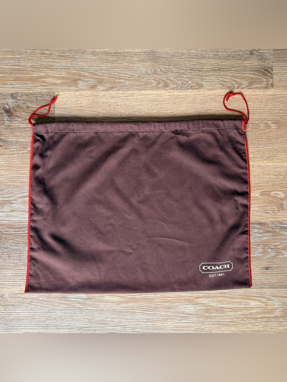 Coach Brown dust bag with red drawstring and contrasting red stitched edging